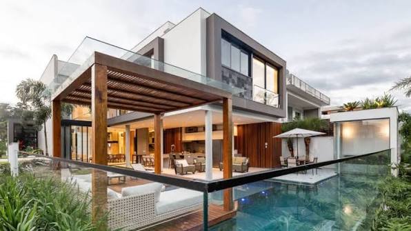 Modern white villa beside a swimming pool and garden