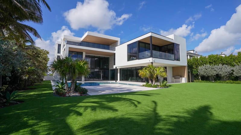 White modern villa surrounded by landscaped greenery